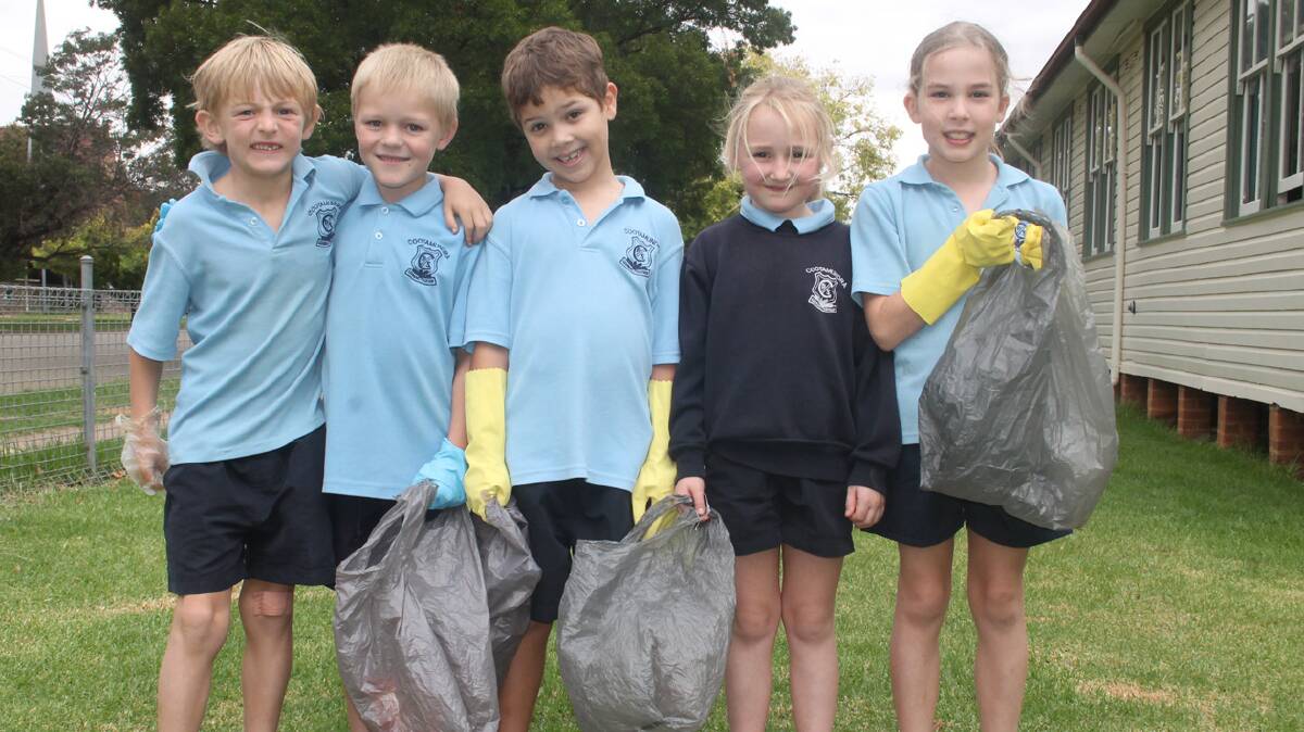  CLEAN UP FUN: While Clean Up Australia Day was officially held yesterday, Cootmaundra’s schools got a head start on the rest of the community with students taking to the grounds with plastic bags and gloves in an attempt to make their school a more beautiful place. Pictured (from left) are Cootmaundra Public School students Toby Lawson, Hunter Slavin, Sam Grewal, Abbie Douglas and Brooke Ronning.

