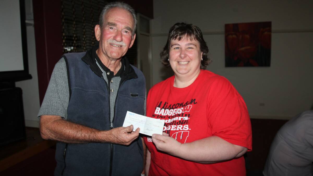 WITH THANKS: Clarrie Power hands over $500, the latest instalment of funds raised from his Collection of Fair Dink joke book, to Can Assist president Tammy Thompson. 
