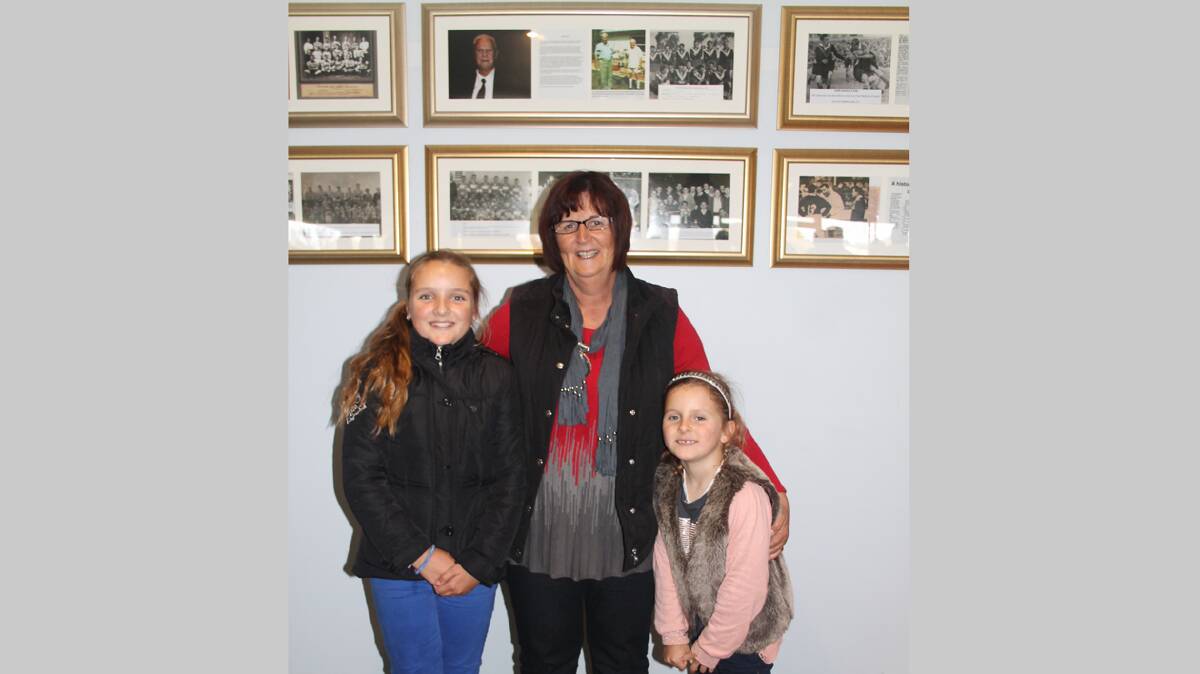 HISTORY MAKING: Pictured with some of the photos from the archives of Wal Galvin which now decorate the clubroom named in his honour is his daughter Sue Chambers and her granddaughters Amelia and Scarlett Chambers. 