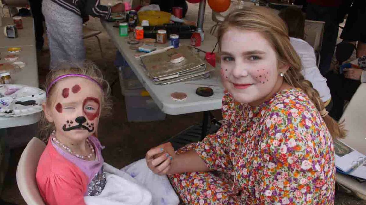  FACE PAINTING: Cootamundra’s Olivia Webster has her face painted by talented CADAS Kids artist Kaede Nicka. 
