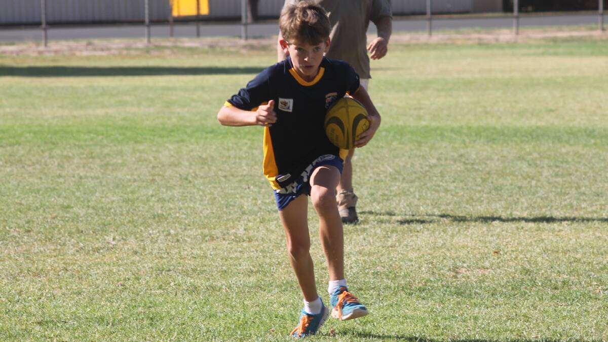  FORWARD: Cootamundra’s Jim Hogan charges forward during his touch football game this week.