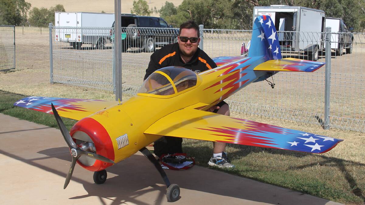 FLYING HIGH:  Wagga scale model pilot Luke Broderick with his yak 55 model aeroplane at the scale acrobatic championships which were held on Sunday. 
Photo: Melinda Chambers