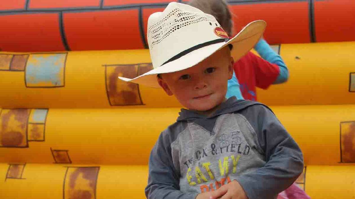  WHAT A CUTIE: Two and a half year old Tristian Collins of Cootamundra loved the jumping castle at Sunday’s Stock Fair. 