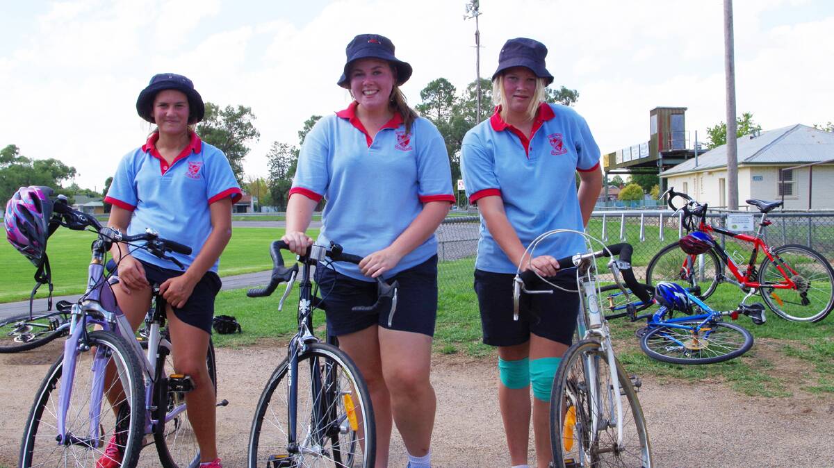 FINISHING STRONGLY: Sacred Heart Central School Year 9 students, from left, Skye Churchill, Phoebe Cheshire and Maddison Heritage after completing the cycling section of the school’s triathlon.