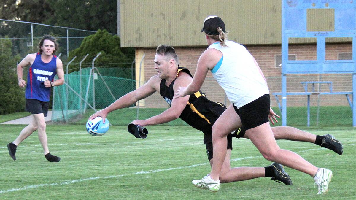 FULL STRETCH: Matt Forsyth scores a diving try for Twomeys in the Unisex A grade grand final held on Monday night. 
Photo: Kelly Manwaring