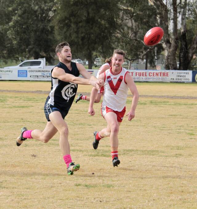 AWAY: Aaron Basham gets the handball away during the Blues' clash with the Goulburn Swans on Saturday. Photo: KELLY MANWARING
