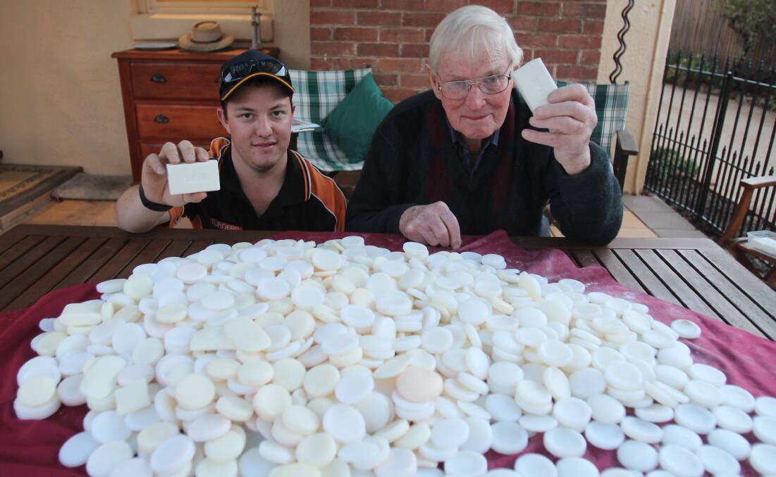 SCRUBBED UP: Rotarians Jacob Sutherland and Hugh Hamilton hold up Soap Aid's finished product and 15 kilos of soap destined to be recycled. Photo: Declan Rurenga