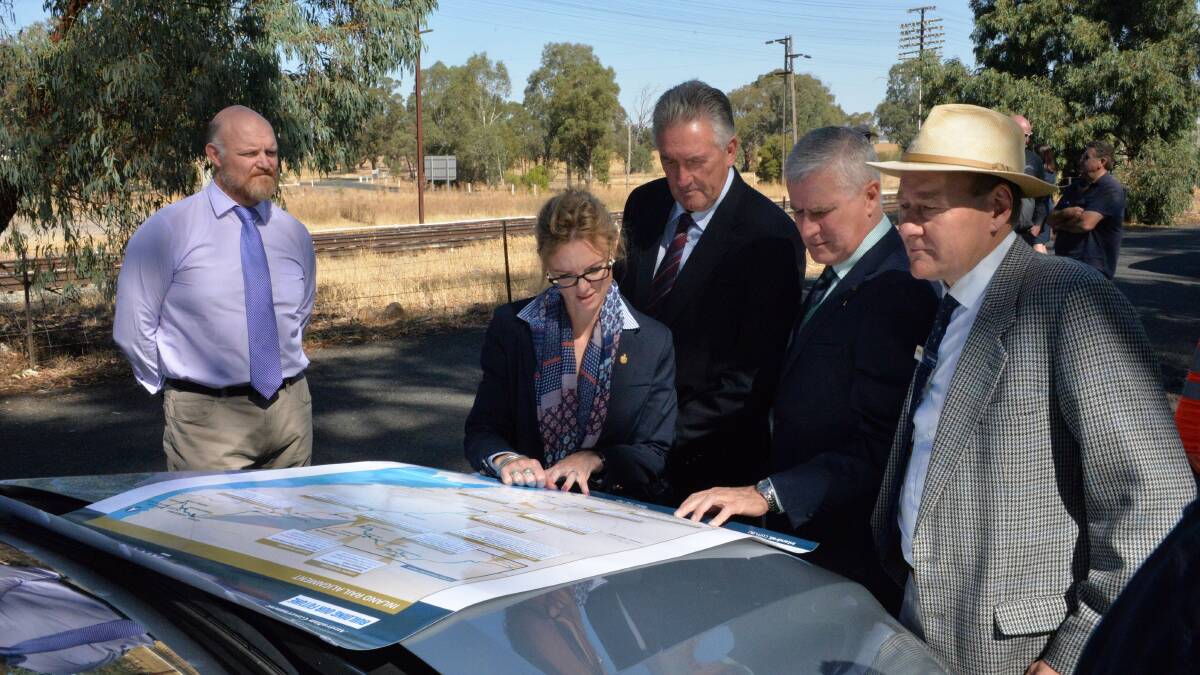 Member for Cootamundra Steph Cooke, Cootamundra-Gundagai deputy mayor Dennis Palmer, Acting Prime Minister and Member for Riverina Michael McCormack and Junee mayor Neil Smith examine the plans watched by ARTC's project manager Cameron Simpkins (left). Photo: Contributed