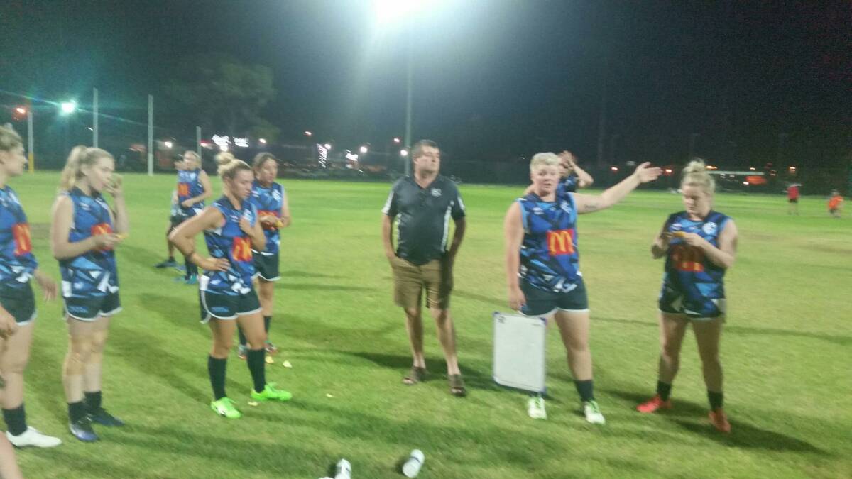 Cootamundra Blues players listen to coach Michael Perceval during the half-time break at the Southern NSW AFLW game in Wagga last Friday. Photo: Contributed