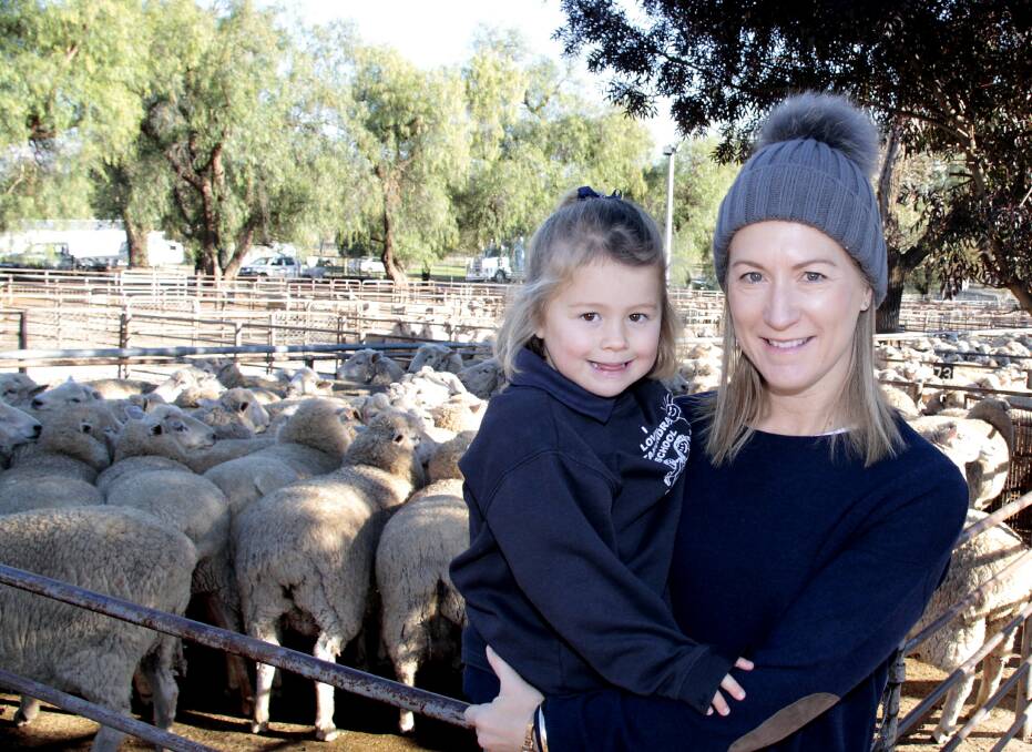 WOOLY FRIENDS: Mary Bassingthwaighte with daughter Arabella at the Cootamundra Saleyards. Photo: Kelly Manwaring