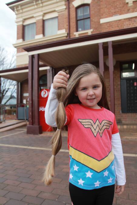 Ava Perry holds up the hair she sent off to Variety to make a wig for a girl who doesn't have her own long hair. Photo: Declan Rurenga