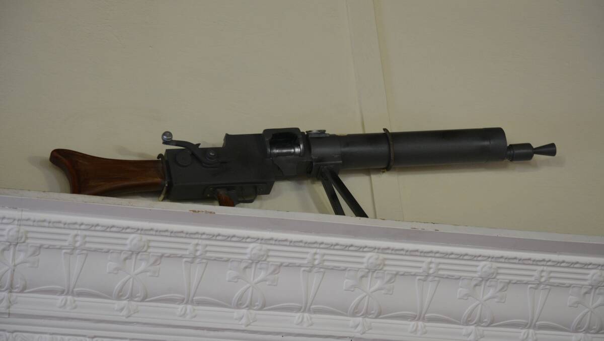 BACK IN PLACE: A German Maxim machine gun was stolen from Wallendbeen Memorial Hall in 1922, however Cootamundra's John Rickett has made a wooden replica. Photo: Contributed