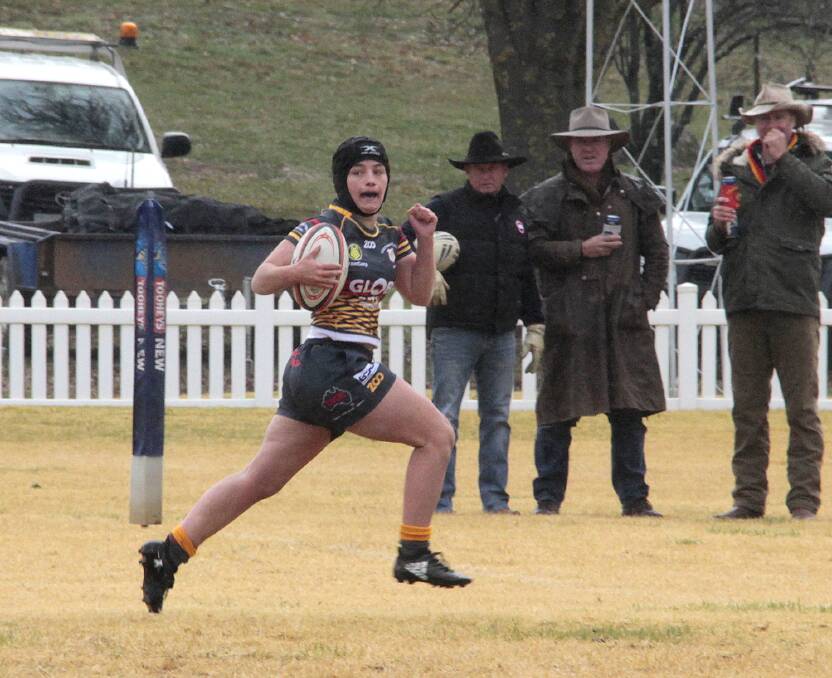 BOUND FORWARD: Libby Perry heads to the try line during Cootamundra's match with Harden at Barry Grace Oval. Photo: Kelly Manwaring