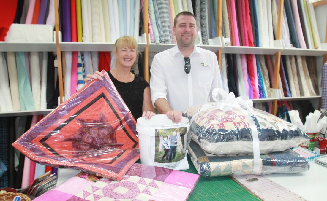 WRAPPED UP: Future Hope MS committee member Wendy Slater with Adam Barnes before drawing he winner of a queen-size quilt. Photo: Declan Rurenga