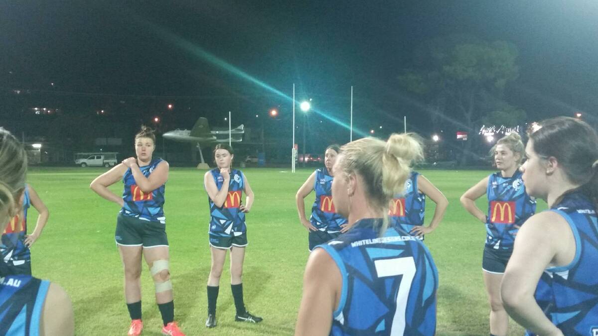 Cootamundra Blues players during the half-time break at the Southern NSW AFLW game in Wagga last Friday. Photo: Contributed