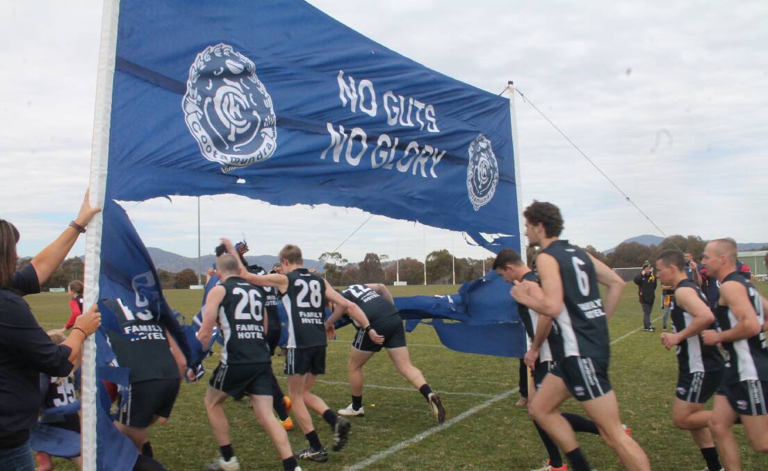 HERE WE GO AGAIN: The Cootamundra Blues run onto Greenway Oval in Canberra during the 2017 grand final game. Photo: Jennette Lees