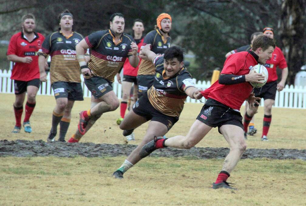 DEVILS DEFEATED: Cootamundra Tricolours' Pita Herangi chases down one of Harden's Red Devils during their game in Wallendbeen. Photo: Kelly Manwaring