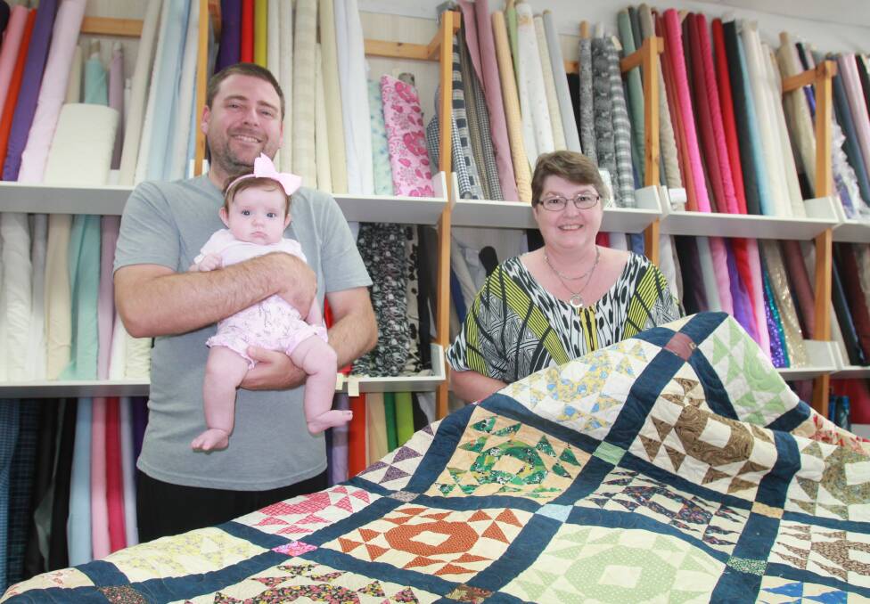 HOPEFUL: Adam and Annabelle Barnes and Patchwork on Parker's Sonia Randall look at the quilt which is being raffled to support Future Hope MS.