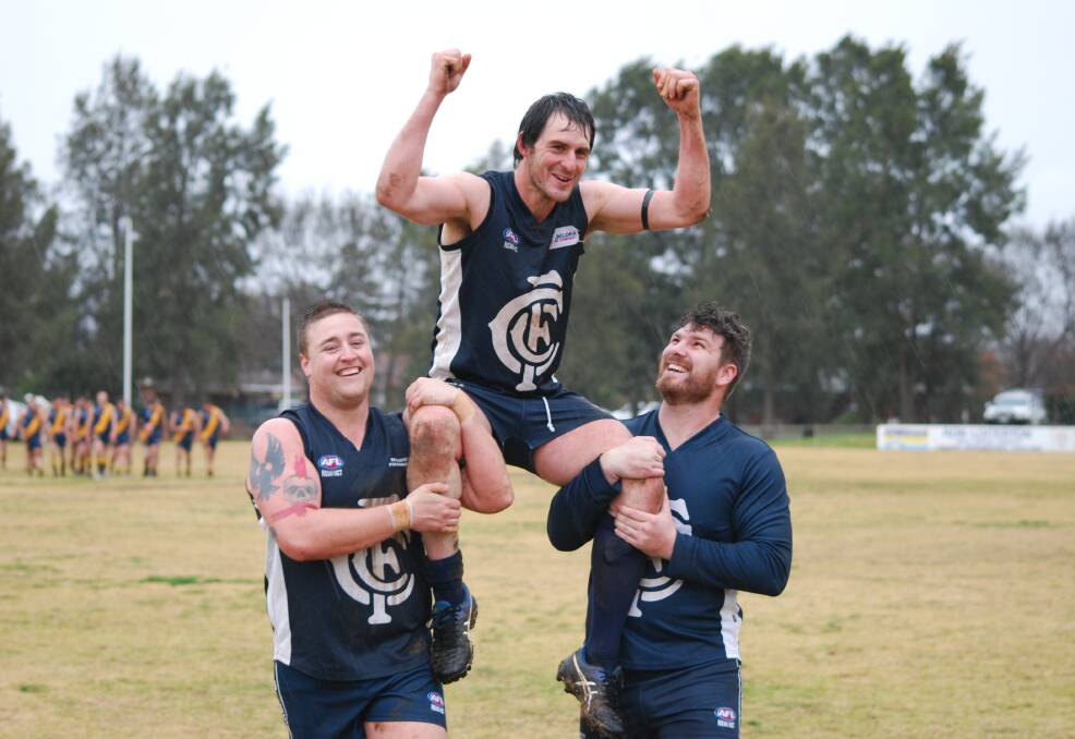CENTURY: Phil Bird is chaired off Clarke Oval on Saturday by Joel Pearson and Sandy Maskell-Knight, after the Blues beat Googong. Photo: Mark Loiterton