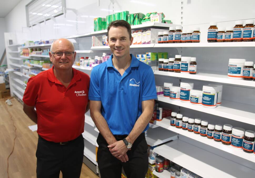 BIGGER AND BETTER: Pharmacists Phil Davies and Hamish Knott have spent this week moving a few doors down into a new shop in Parker Street. Photo: Declan Rurenga