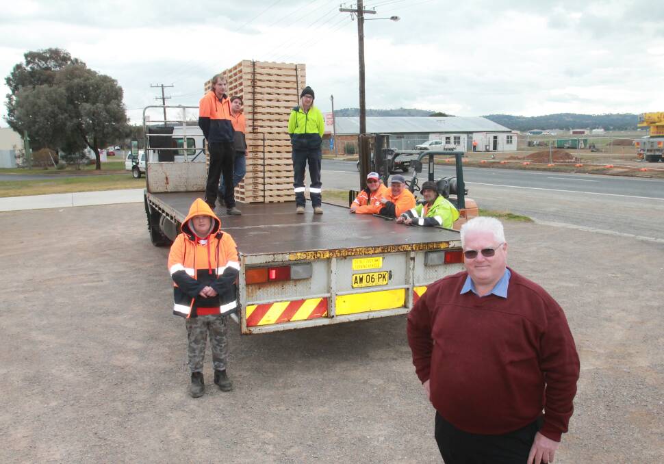 LOADING ZONE: Elouera Association CEO Allan Young with employees as they load another truck on Thursday. Photo: Declan Rurenga