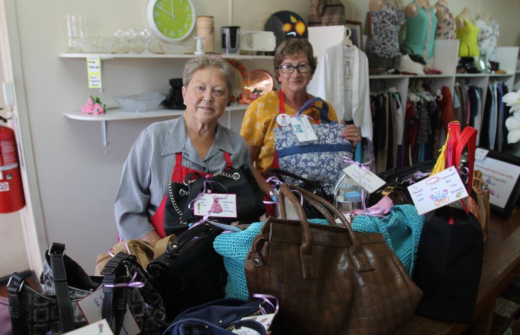 ESSENTIALS: Red Cross volunteers Helen Eccleston and Nerida Kelly with 24 handbags filled with tolietries and essentials for women fleeing domestic violence. Photo: Declan Rurenga