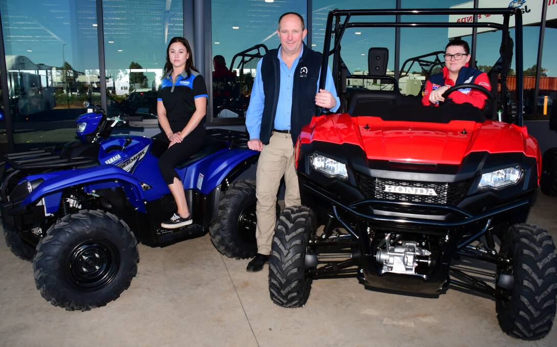 SAFETY STANDARDS: Work, Rest, Play's Amber Sutcliffe, dealer principal Chris Gibson and Melody Iwikau-Luxford with a quad bike and side-by-side. Photo: BELINDA SOOLE