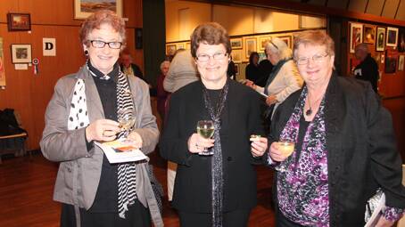ENJOYING THEMSELVES: local ladies (from left) June Stapleton, Pat Roberts and Helen Smith had a great time checking out the works of art at Friday’s opening of the Wattle Time Art Exhibition. 