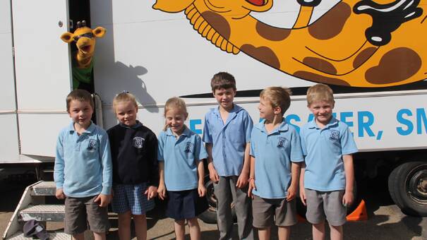 READY TO LEARN: Cootamundra Public School infants students (from left) Will Ellis, Grace Neale, Niketa Smart, Joe Harpley, Tom Tooth and Charlie Tregear are pictured out the front of the Life Education van, which arrived at their school on Wednesday. Even Healthy Harold wanted to be in on the action making a special appearance for the photo. 