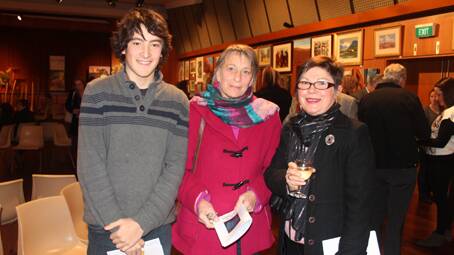 LOVELY EVENING: catching up at the Wattle Time Art Exhibition opening are Bowral visitors Hugh Savill and Kim Shannon and local lady Leigh Bowden (right). 